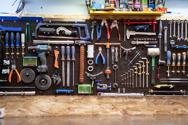 Plumbing tools on a workshop wall